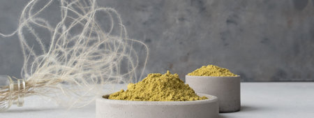 Banner. henna powder for dyeing hair and eyebrows and drawing mehendi on hands on a gray cement...