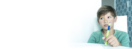 Banner. Smiling boy with textbook does school homework. Back to school. happy schoolboy. Distance learningの写真素材