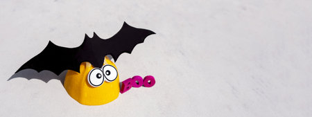 Banner. Trendy minimalistic concrete background for the Halloween holiday. Boo word. Black batの写真素材