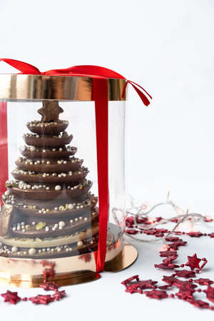 Christmas tree with edible decorations in box. Christmas food, homemade chocolate dessert. Creative Christmas ideas. New year present or giftの写真素材