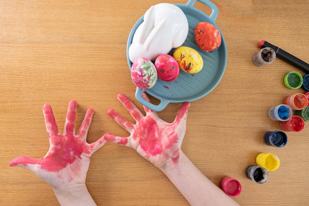 Cute little boy 8 years old painting easter eggs with paint brushes. concept of kid creativity, diy, handmade. ideas for kindergarten. paint eggs for Easter holiday. Preparing for celebration is a joy for kids.の写真素材