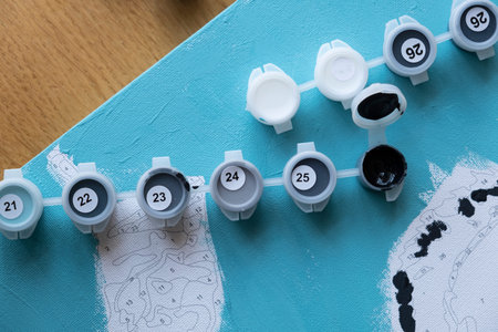 paints for drawing by numbers in blue and turquoise tones, draws a picture by numbers. children's...