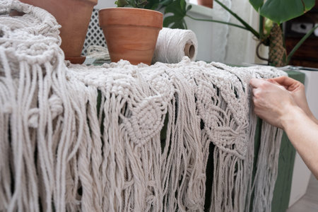 womens hands weave macrame panels. cotton threads, yarn for the manufacture of hand-made products...