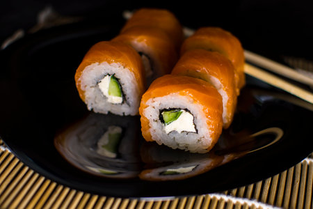 sushi rolls is an Asian rice dish served with soy sauce, ginger and wasabiの写真素材