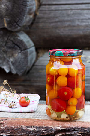 Tomatoes in a glass jar, homemade picklesの写真素材