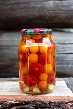 Tomatoes in a glass jar, homemade picklesの写真素材