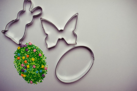 Easter background with cookie cutter and sugar sprinklesの写真素材