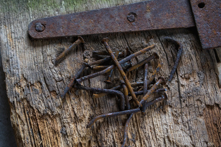 Group of rusty old nails an old piece of wood.の写真素材