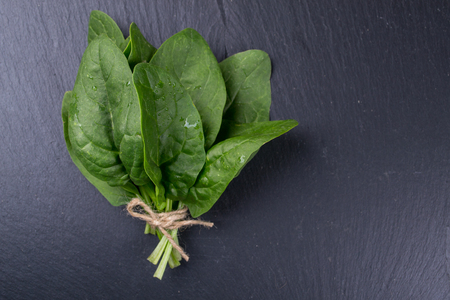 Freshly picked spinach on  the black board, top view, Space for text Background for a recipe.の写真素材