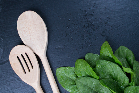 Freshly picked spinach on  the black board, top view, Space for text Background for a recipe.の写真素材