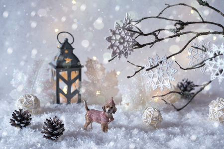 Toy dog Labrador in the frosty winter wonderland with snowfall and magic lights.  New year greetings conceptの写真素材