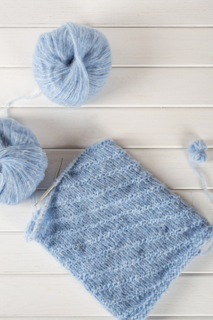 Blue knitting wool yarn and knitting needles. Incomplete knitting projectの写真素材