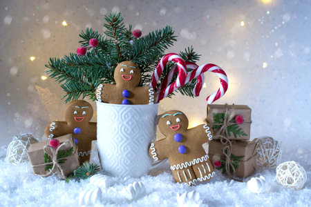 Christmas or new year card . Cup with fir trees, candy canes and ginger cookies. On snow bright...