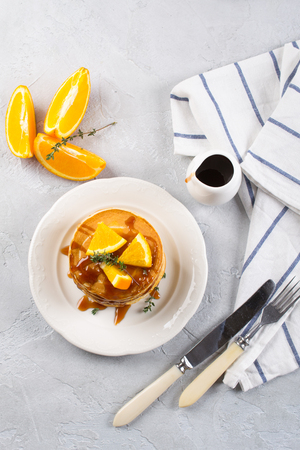 Fresh delicious sweet American pancakes on a plate with fresh fruits and sprinkled syrup. For breakfast. Flat layの写真素材