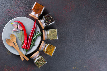 Colorful spices and herbs for cooking background and design top view. Flat layの写真素材