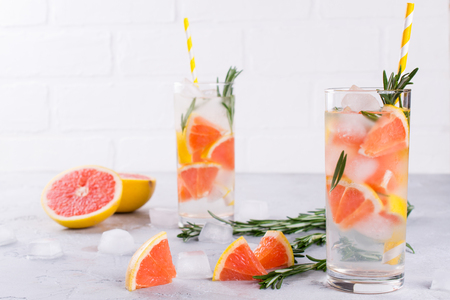 Fruit and herb infused water. Cold refreshing vitamin detox water. Summer drinkの写真素材