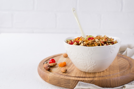 Bowl with homemade granola on white background for healthy breakfast . Healthy snak. の写真素材