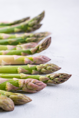 Spring season food.   Fresh white and green asparagus on a gray concrete background.  Space for text.Background for a recipe.の写真素材