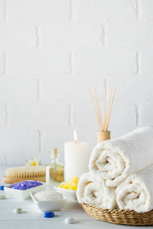 Body care set for peeling. With towel,white lily, sea salt, bath oil, sugar body scrub, massage brush and candleの写真素材