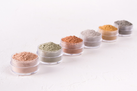Set of different cosmetic clay mud powders on white backgroundの写真素材