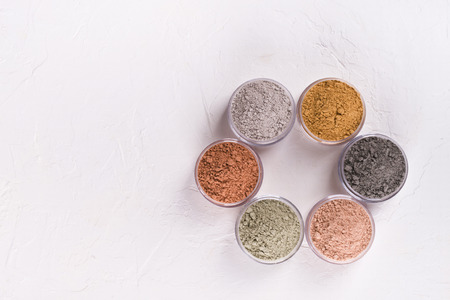Set of different cosmetic clay mud powders on white backgroundの写真素材