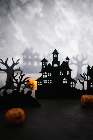 Mysterious night landscape with houses silhouettes and graveyardの写真素材
