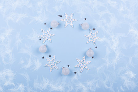 Circle round frame of Christmas decorations and snowflake on pastel blue background, flatlay, with...