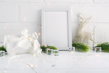 Christmas home decoration with white frame and christmas tree branches, deer and lights on white background. Mock-upの写真素材