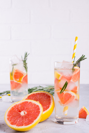 Fruit and herb infused water. Cold refreshing vitamin detox water. Summer drinkの写真素材