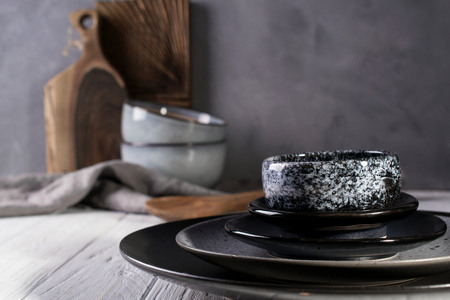 Collection of  natural  rustic  handmade crockery tableware in neutral tones on grey backgroundの写真素材
