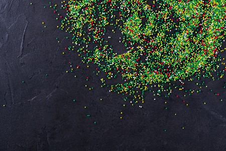 Sugar sprinkle dots, decoration for cake and bakery, as a background. On blackの写真素材