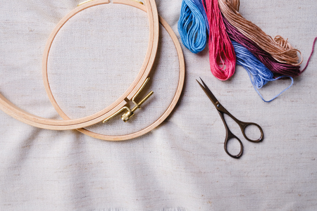 Embroidery set. White linen fabric, embroidery hoop, colorful threads and needls. Copy spaceの写真素材