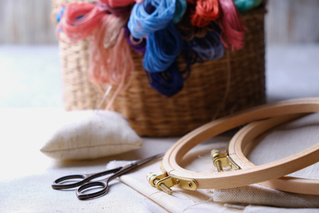 Embroidery set. White linen fabric, embroidery hoop, colorful threads and needls. Copy spaceの写真素材