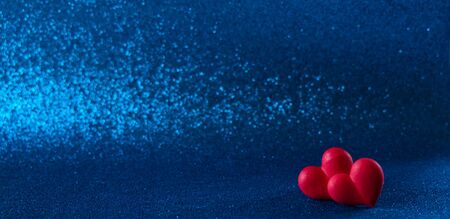 Bright red hearts abstract blue  bokeh background
 Valentines day texture.
の写真素材