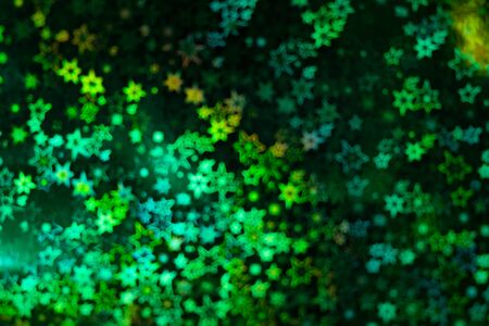Holographic  green background with abstract colorful blur stars shaped bokehの写真素材