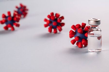 Vaccine for coronavirus 2019-nCoV.
 and models of covid-19 virus on blue background. Stop coronavirus.
 concept. Epidemic, vaccine saving life.の写真素材