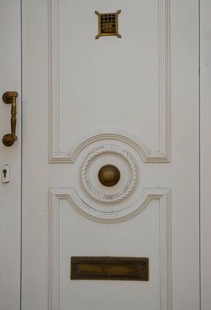 Old metal door handle lock on white wooden door. Door knobの写真素材