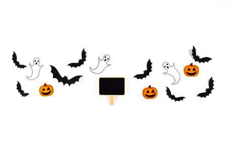 Halloween mock up concept. Flying black paper bats, pumpkins and ghosts, black tag on white...