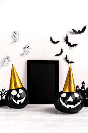 Halloween mock up. Black photo frame and paper art abandoned village, pumpkin on white background.の写真素材