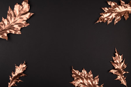 Autumn composition. Golden maple leaves on black background. Autumn, fall concept. Flat lay, top...