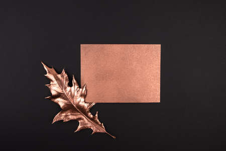 Autumn composition. Golden maple leaves on black background. Autumn, fall concept. Flat lay, top view, copy space. mock up with golden curd for textの写真素材