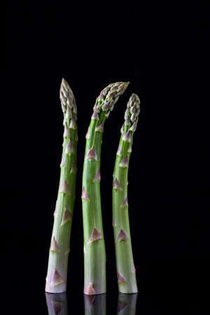 Fresh organic green asparagus isolated on black background. closeup shotの写真素材