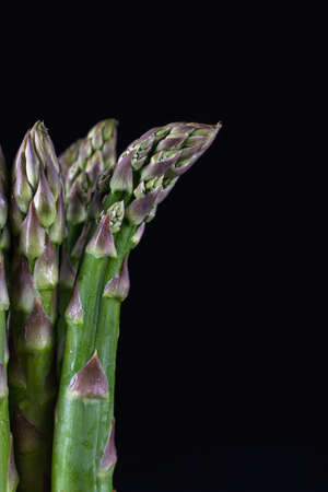 Fresh organic green asparagus isolated on black background. closeup shotの写真素材