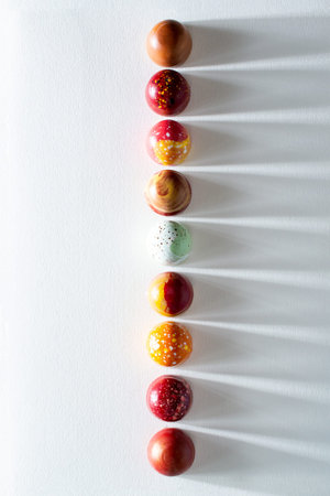 Modern hand painted with different colors chocolate candy placed in a row. product advertising...