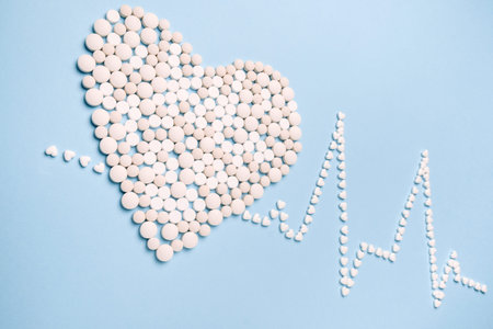 Pills in shape of the heart and heart rhythms. ECG. medicine, healthcare and pharmacy concept