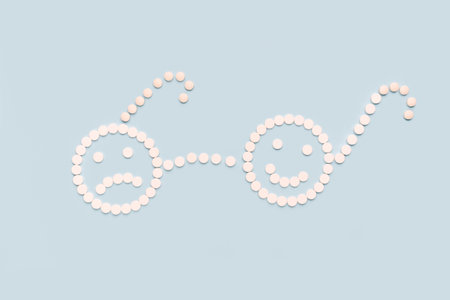 A sad and a happy face made of pills. Sick and healthy concept The concept of antidepressants and healingの写真素材