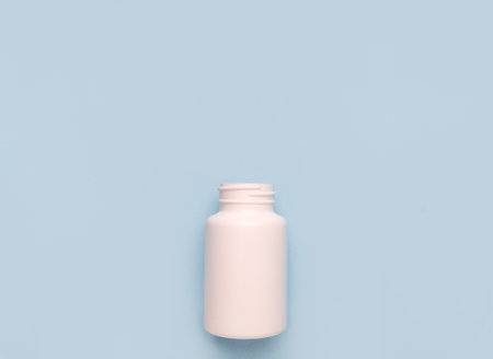 White plastic bottle medicine on blue backgroundの写真素材