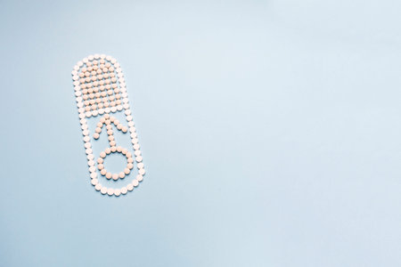 Men's health concept in November and September month. Concept of erection, potency. Treatment of male infertility and impotence. The capsule is made of pills and male symbolの写真素材