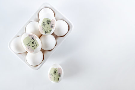 Modern creative trendy hand painted easter egg in a ceramic stand on white background. Homemade tradition Easter ideasの写真素材