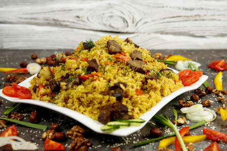 Uzbek, Kazakh national dish - pilaf. Rice with meat and vegetables. Menu for the restaurant.の写真素材